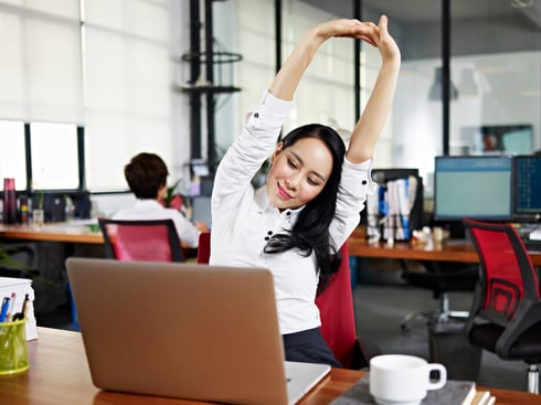 Woman at Computer Stretching GettyImages-501332192.jpg